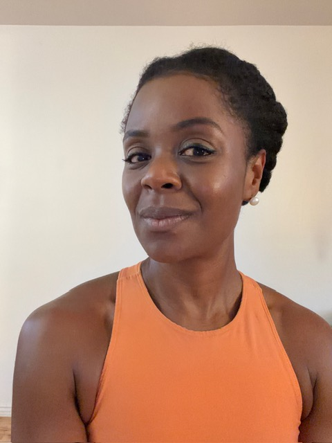 Portrait of Dani in an orange tank top