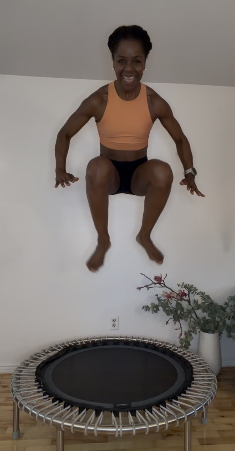 Dani mid-jump on a fitness trampoline